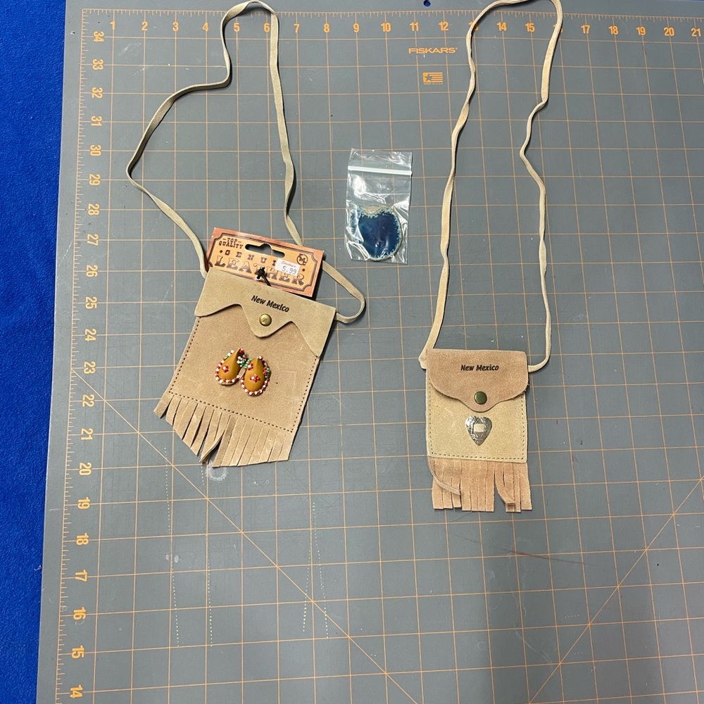 Beige Leather Fringe Pouch with Beaded Accents has some stains
